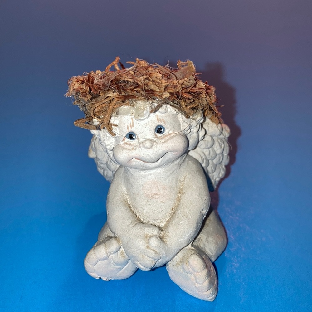 Appx. 2 1/2” x 1 3/4” child angel w/big smile, curly hair, beaded eyes. $10
